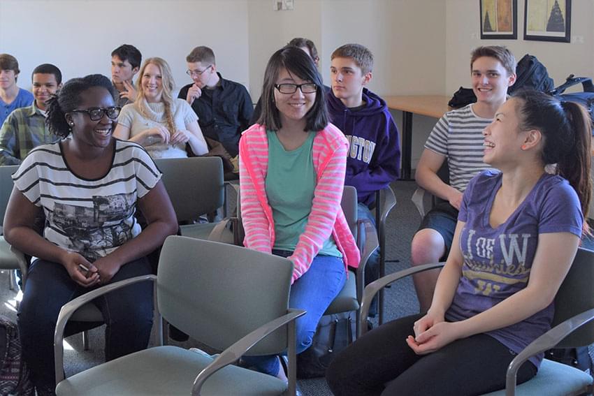 Ewurama Karikari with classmates in a classroom